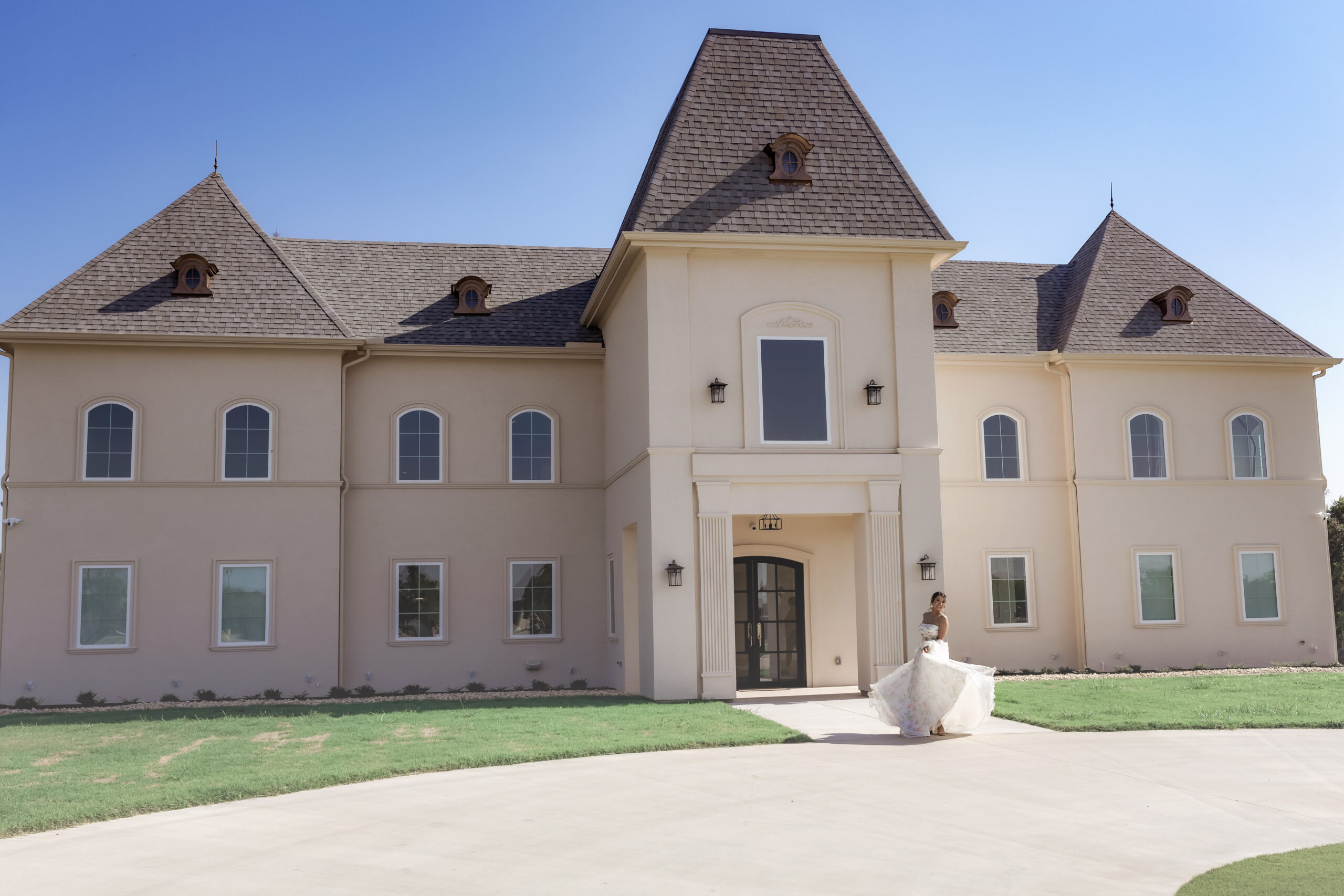 Photograph of Chateau Joli Wedding Venue with Bride out front twirling in her dress