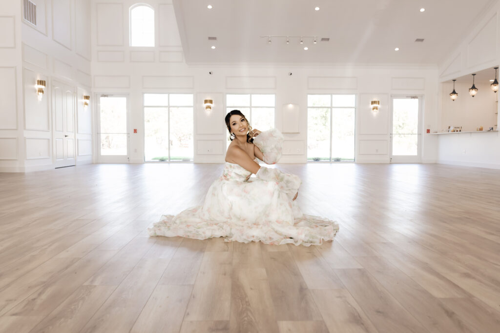 Bride in a pool of her dress in the middle of reception hall at Chateau Joli Wedding Venue, by Dallas wedding photographer Arlene Stepanian 